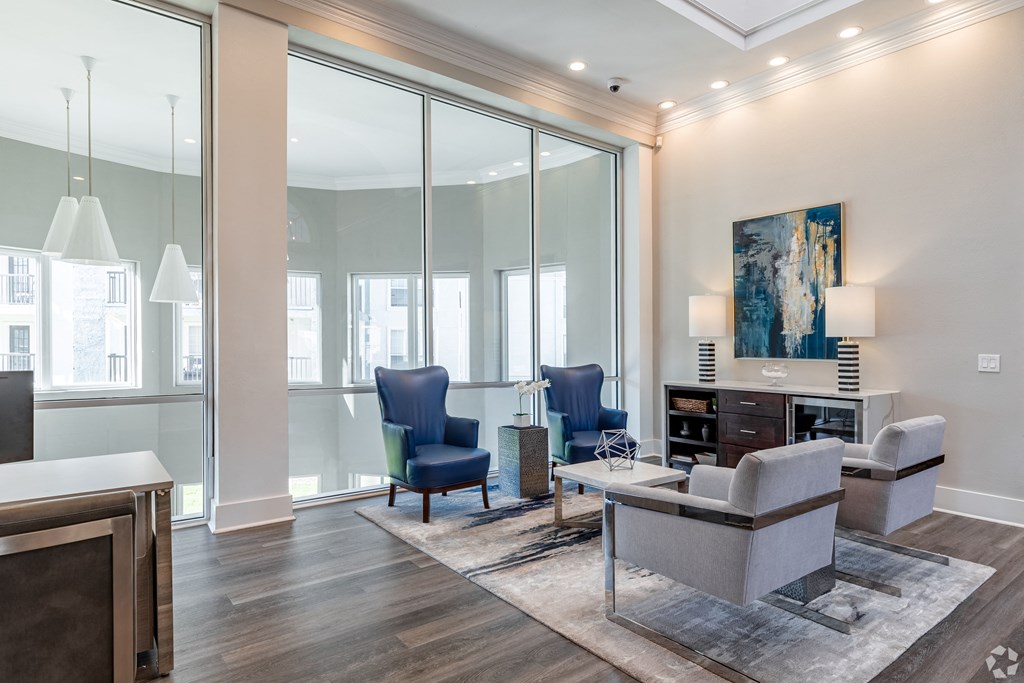 a living room filled with furniture and a large window
