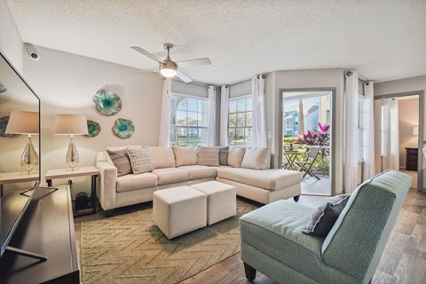 our apartments offer a living room with a sofa chair and ottoman