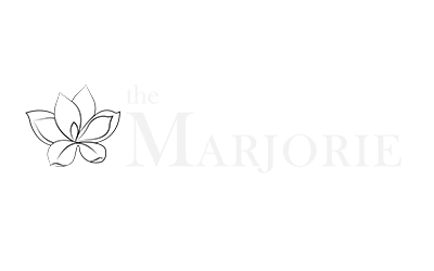 The Marjorie logo with a white lotus flower on a green background.