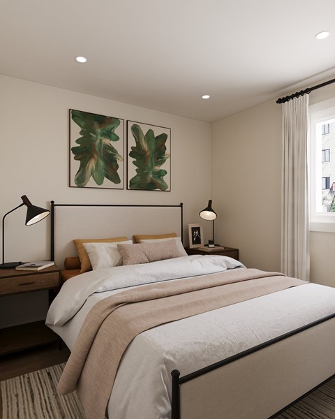 A bedroom with a large bed and two lamps.