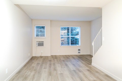 A room with a window and a staircase.