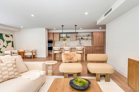 A modern living room with a white sofa and wooden furniture.