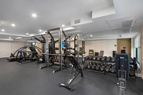 A gym with a variety of equipment including weights and machines.