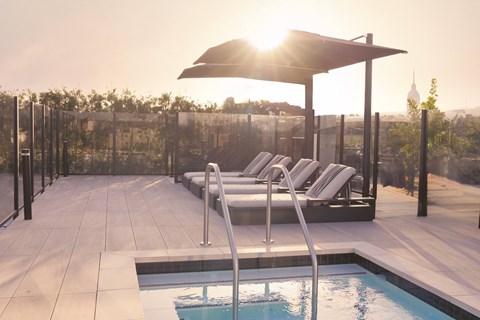 A sunny day at the pool with sunlight shining through the umbrella.
