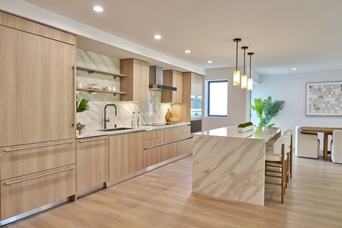 A modern kitchen with wooden cabinets and a central island.