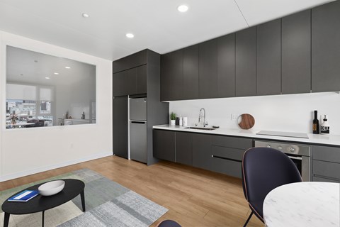 A modern kitchen with a dining table and chairs.