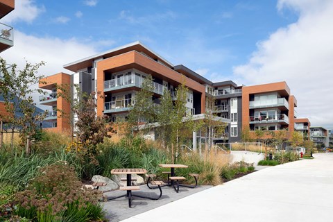 A modern building with a courtyard and benches.