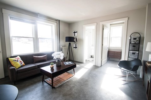 A living room with a brown couch and a coffee table.
