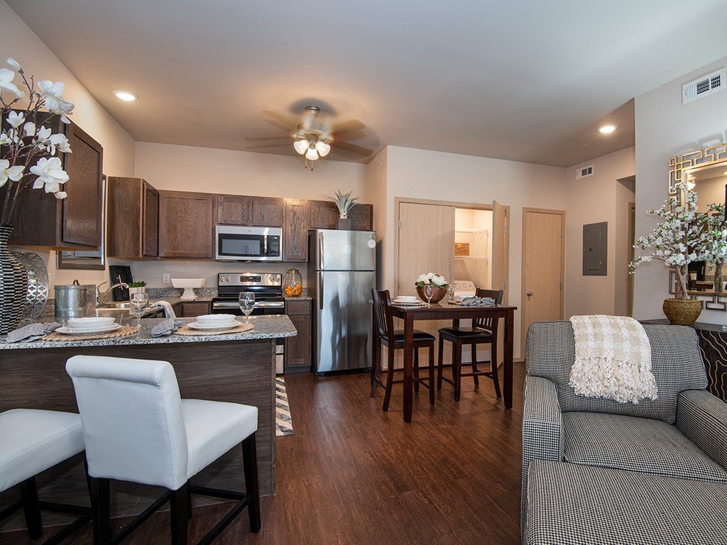a kitchen and living room with a couch and a table