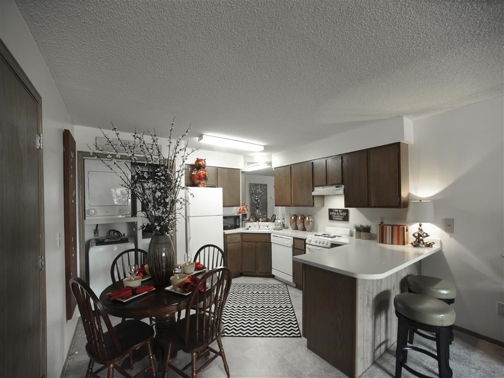 a kitchen and dining room with a table and chairs