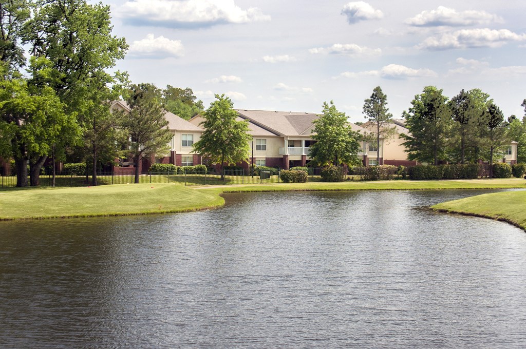 A lake in front of a row of houses.