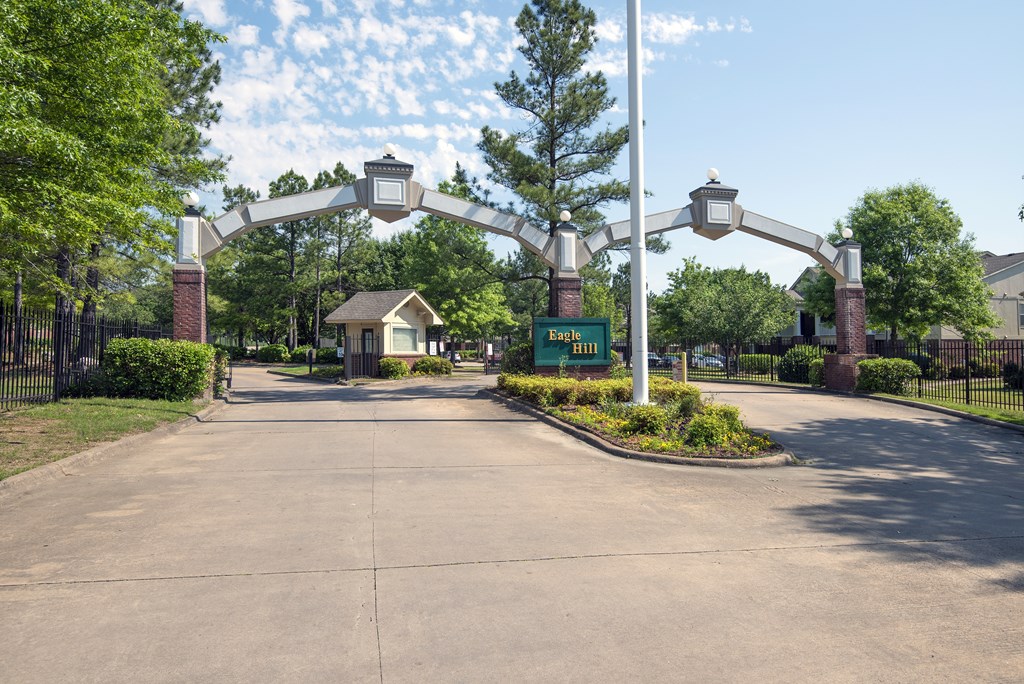 A green sign with the word "Exit" is in front of a gate.