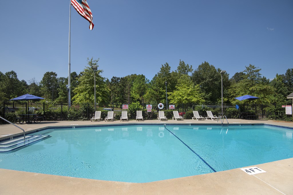 A pool with a flag on a pole.