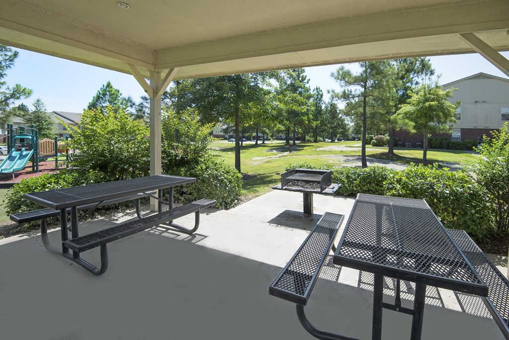 A covered picnic area with tables and benches.