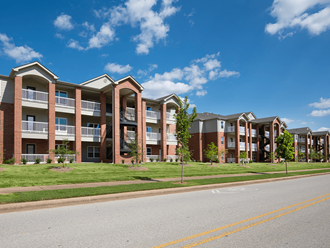 an exterior view of an apartment complex on a sunny day