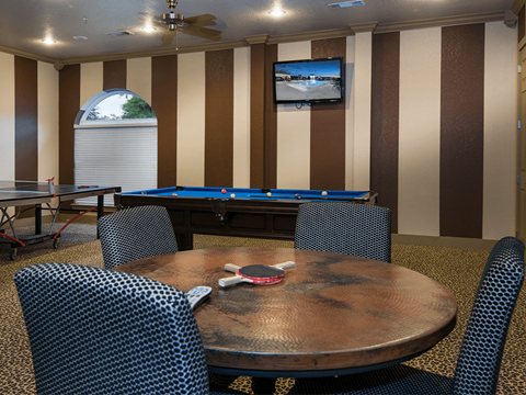a game room with a pool table and ping pong table
