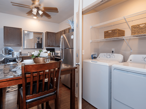 a kitchen and dining room with a washer and dryer
