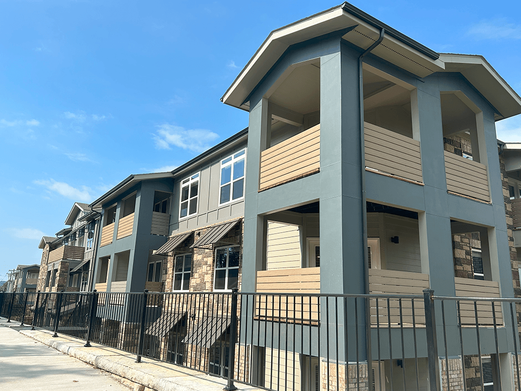 a row of townhomes with a blue sky in the background