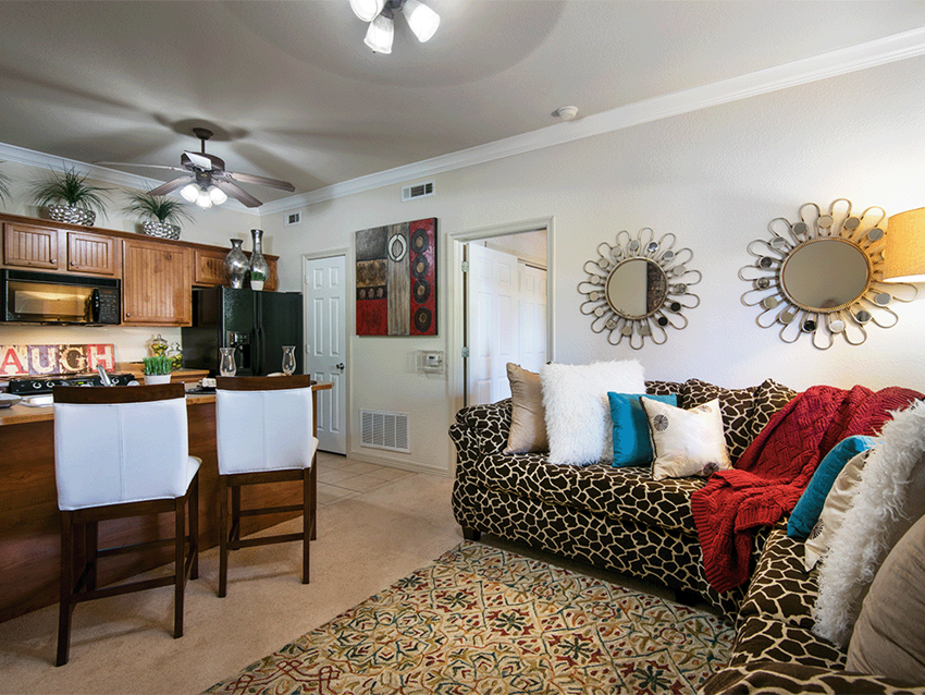 a living room and kitchen with a couch and a table