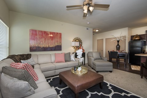 A living room with a grey couch and a brown coffee table.