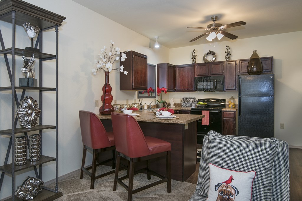 A kitchen with a table and chairs and a decorative pillow.