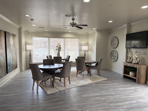 A dining room with a table set for four.