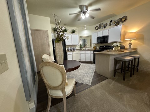 A kitchen with a chair in front of it.