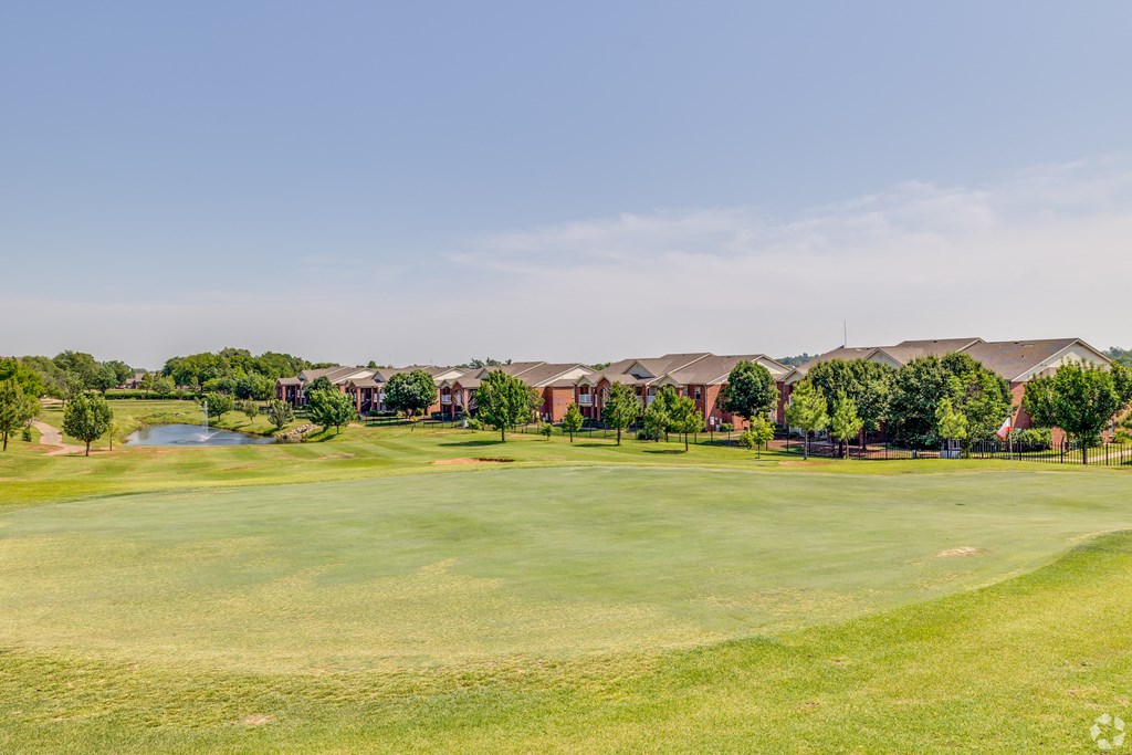 a golf course with houses in the background