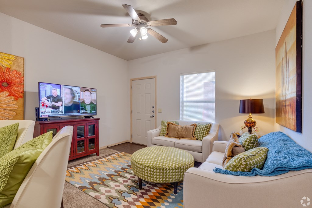a living room with a couch and a chair and a tv