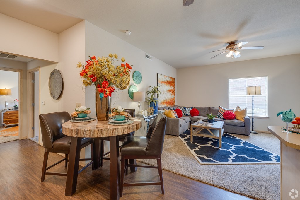 an open living room and dining room with a table and chairs
