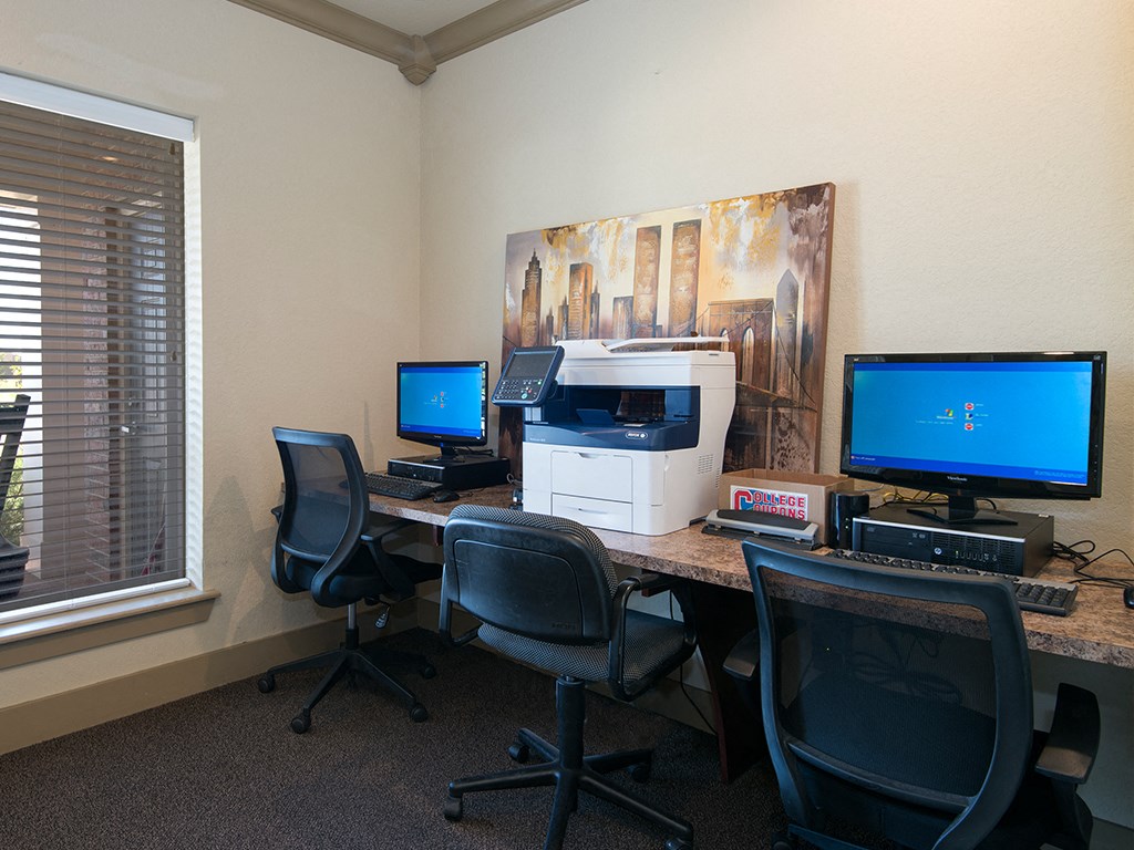 A room with two computers and two chairs.