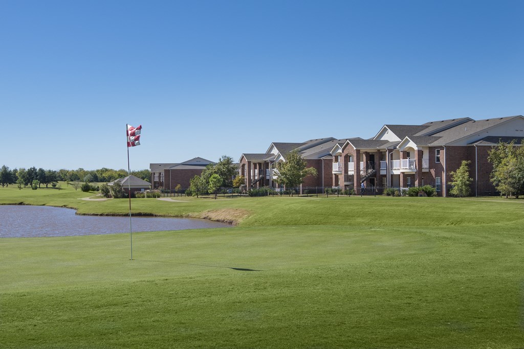a golf course with a flag in front of a building