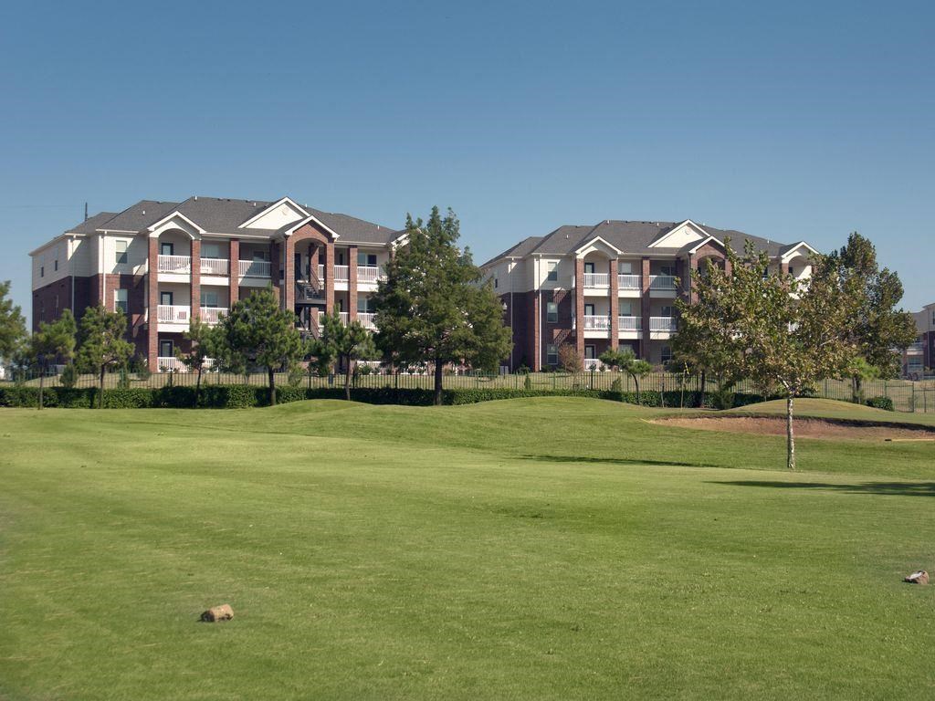 a golf course in front of an apartment building