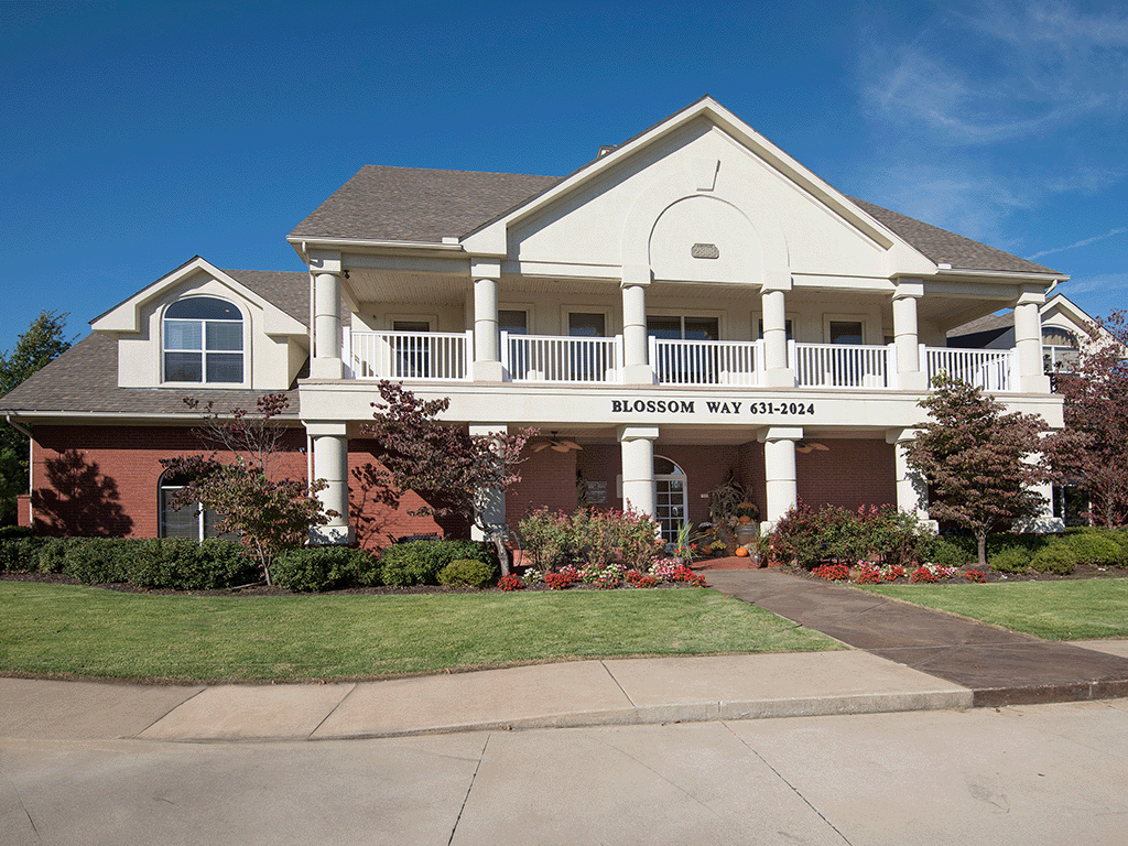 a house with a porch and a sidewalk in front of it