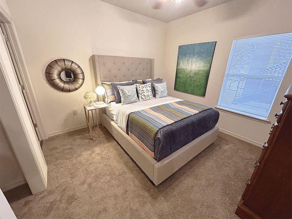 a bedroom with a bed and two windows