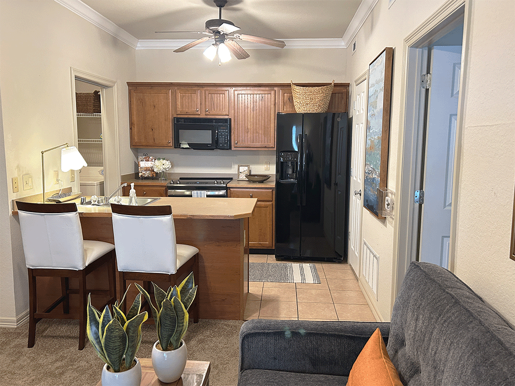a kitchen and living room with a table and chairs