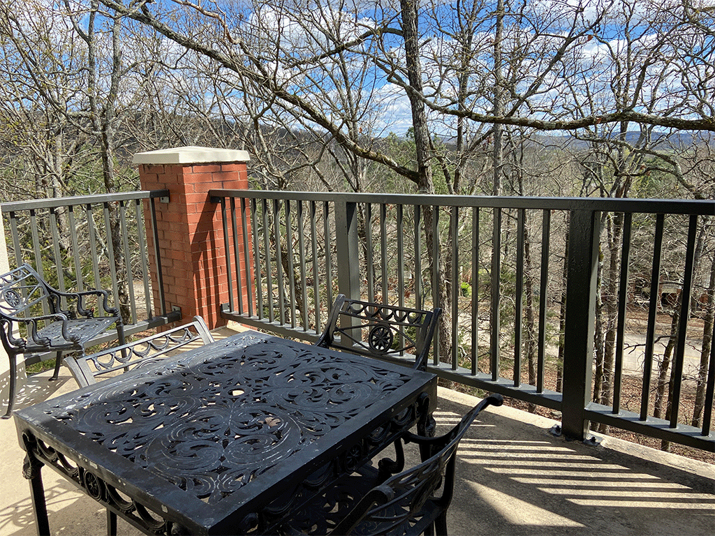 a patio with a table and chairs on a balcony