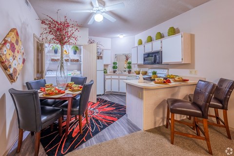 a dining room and kitchen with a dining table and chairs