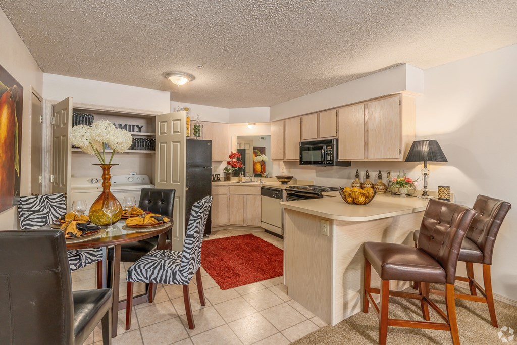 a kitchen and dining room with a table and chairs