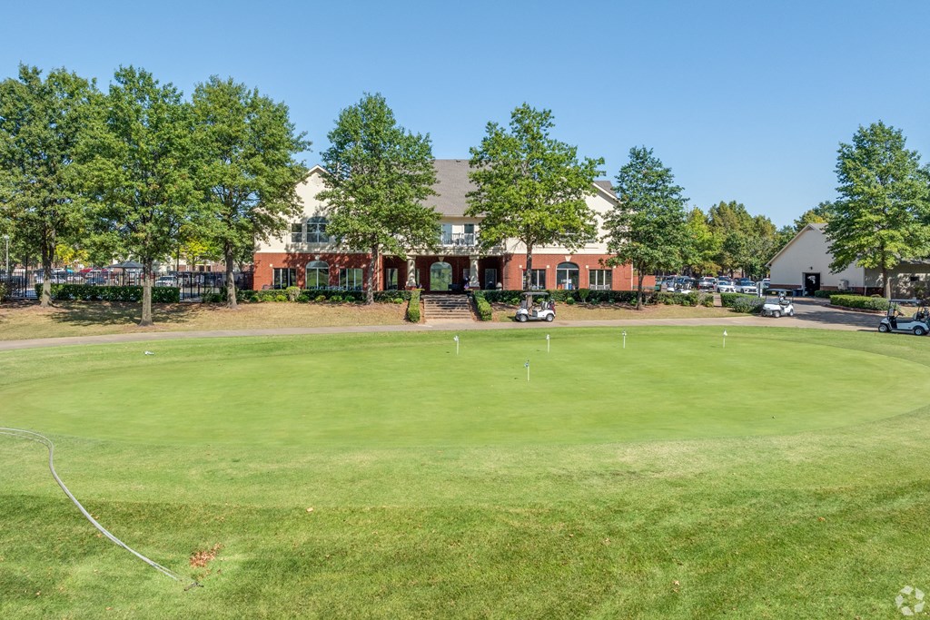 a golf course with a building in the background