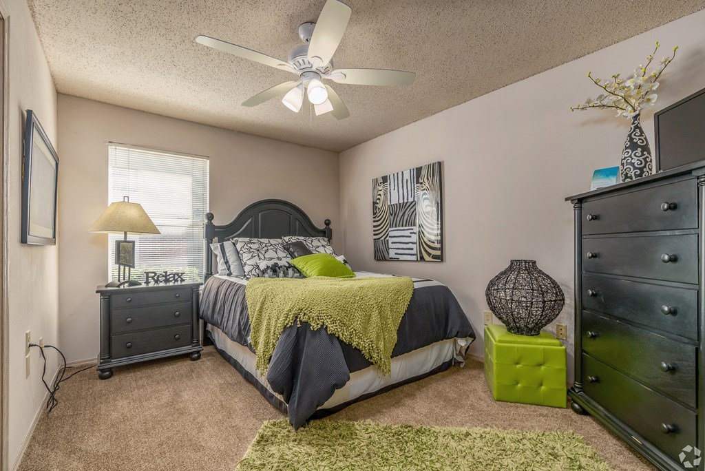 a bedroom with a bed and a ceiling fan