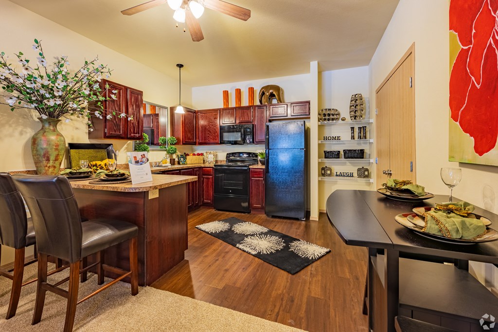 a kitchen and dining area with a table and chairs