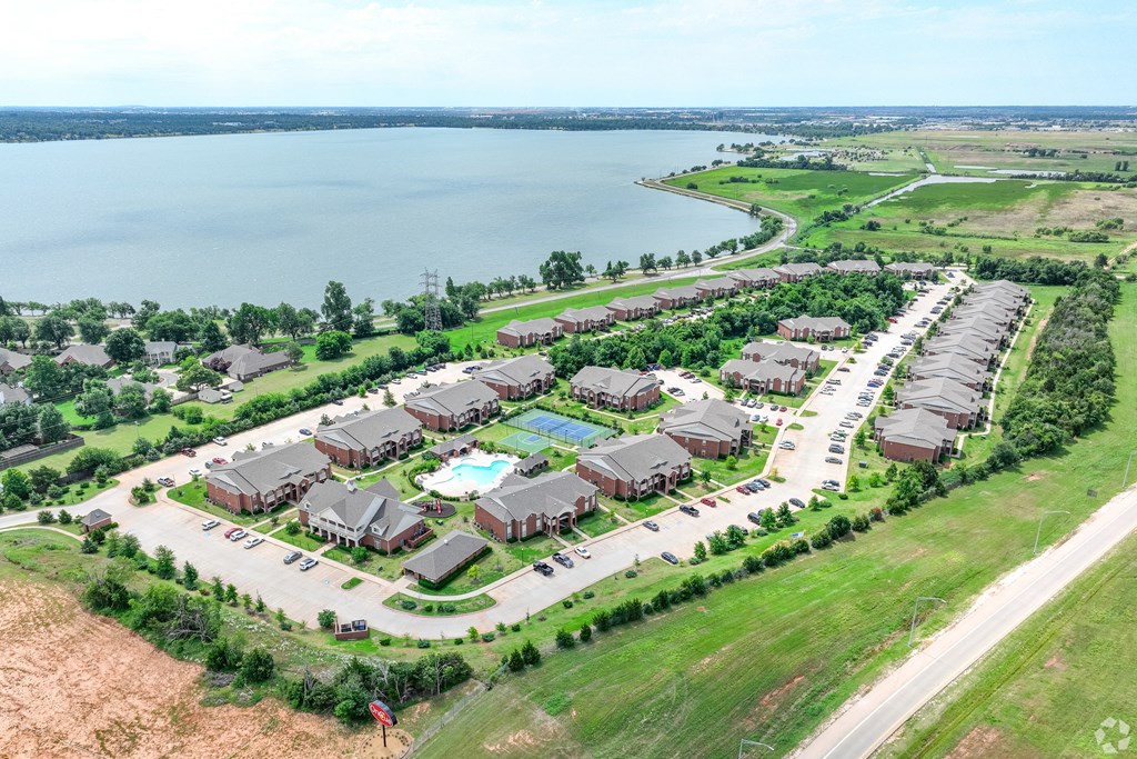 an aerial view of a neighborhood of houses near a lake