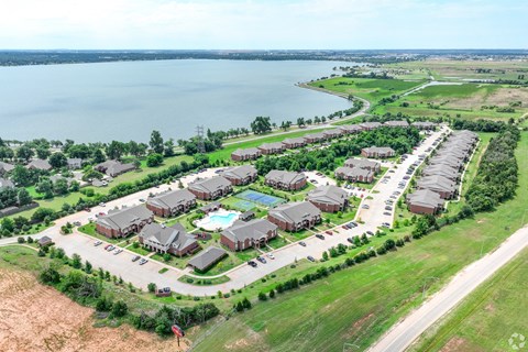 an aerial view of a neighborhood of houses near a lake