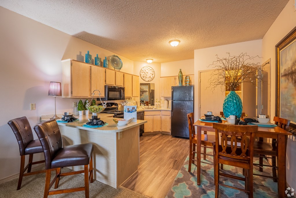 an open kitchen and dining area with a dining table and chairs