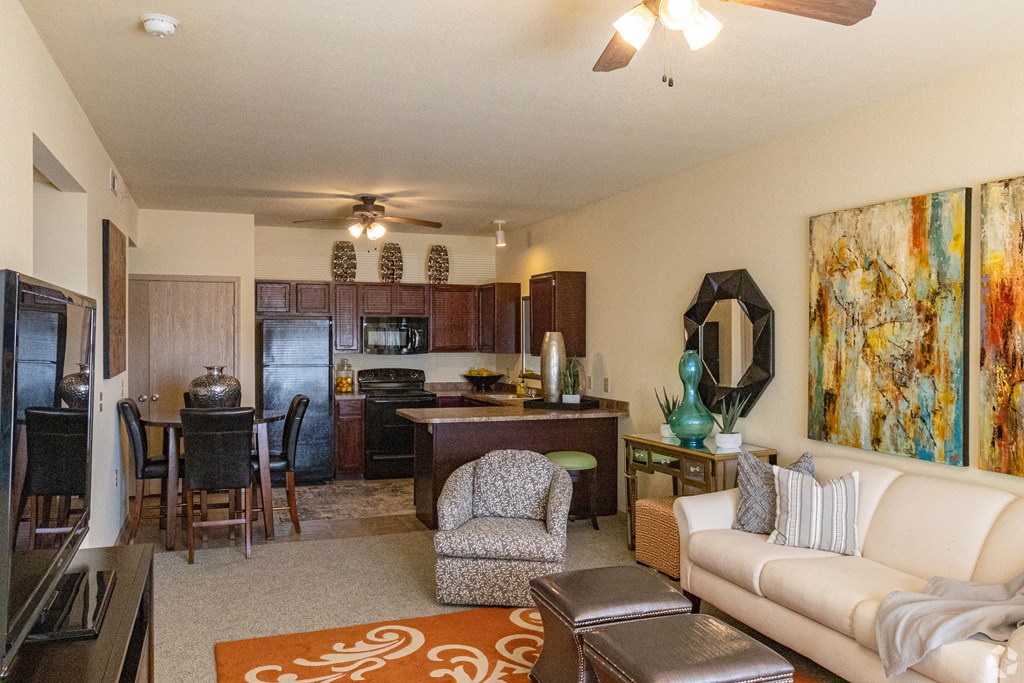 a living room and kitchen with a couch and a table
