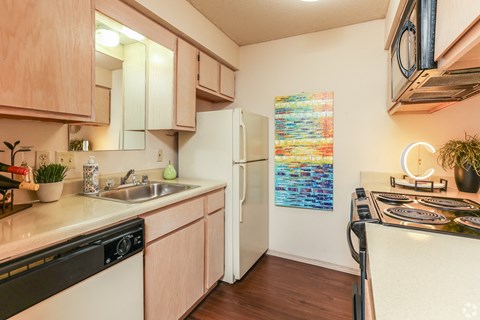a kitchen with a sink and a refrigerator and a stove