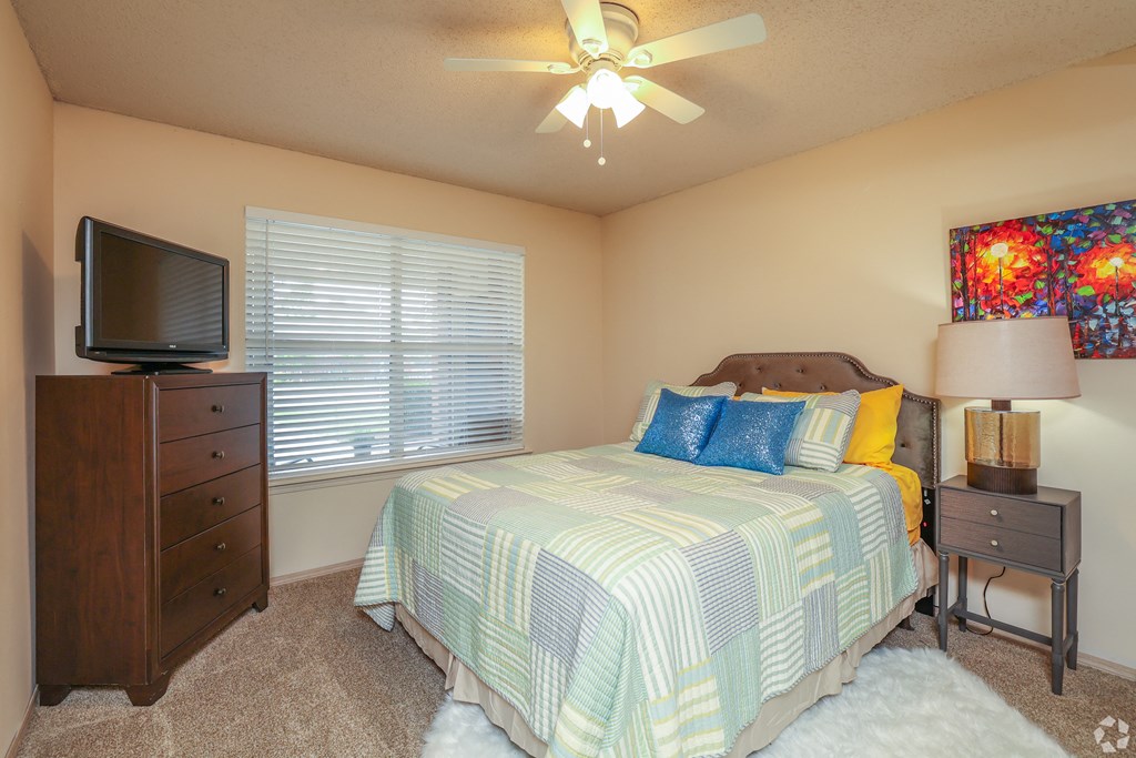 a bedroom with a bed and a tv