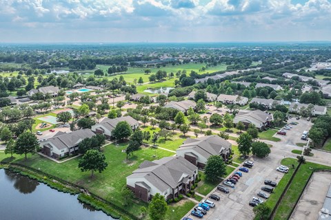 an aerial view of a neighborhood of houses near a body of water