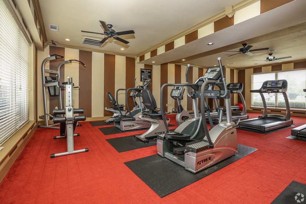 a gym with treadmills and other exercise equipment